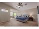 Spacious bedroom with vaulted ceilings, fan, and sitting area with large windows and lots of natural light at 15324 W Windsor Ave, Goodyear, AZ 85395