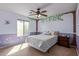 Cozy bedroom with unique tree-themed wall art, ceiling fan, and comfortable furnishings at 15324 W Windsor Ave, Goodyear, AZ 85395