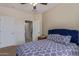 Cozy bedroom featuring blue bedding, with access to bathroom creating a harmonious and relaxing atmosphere at 15324 W Windsor Ave, Goodyear, AZ 85395