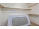 Walk-in closet with built-in shelving and ample storage space; perfect for organizing clothing and accessories at 15324 W Windsor Ave, Goodyear, AZ 85395