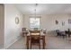 Bright dining room with wood floors, a chandelier, and seating for six at 15324 W Windsor Ave, Goodyear, AZ 85395