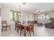 Bright dining room with a wood table, chairs, and modern lighting fixture at 15324 W Windsor Ave, Goodyear, AZ 85395