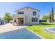 Home's backyard with lush lawn, patio, and modern exterior design, perfect for outdoor living at 15324 W Windsor Ave, Goodyear, AZ 85395