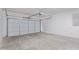 Spacious two car garage with concrete floor and a white garage door at 15324 W Windsor Ave, Goodyear, AZ 85395
