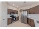 Modern kitchen with stainless steel appliances and white countertops at 15324 W Windsor Ave, Goodyear, AZ 85395
