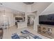 Open concept living room, kitchen, and dining area featuring light colored floors and modern decor at 15324 W Windsor Ave, Goodyear, AZ 85395