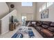 Spacious living room with high ceilings, large windows, and a comfortable sectional sofa at 15324 W Windsor Ave, Goodyear, AZ 85395