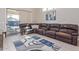 Living room with large sectional sofa, area rug, and sliding door access to the backyard at 15324 W Windsor Ave, Goodyear, AZ 85395