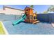 Detailed wooden play structure with a slide and seating area, perfect for entertainment at 15324 W Windsor Ave, Goodyear, AZ 85395