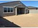 Backyard view with covered patio and block wall fencing at 17788 W Odeum Ln, Goodyear, AZ 85338