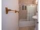 Cozy bathroom featuring a tub/shower combination with glass doors and pedestal sink at 1836 W Las Palmaritas Dr, Phoenix, AZ 85021