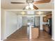 Bright open floor plan features wood floors, a ceiling fan and easy access to kitchen at 1836 W Las Palmaritas Dr, Phoenix, AZ 85021