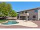 Backyard featuring a pool, patio, privacy fence, decorative rock and a mature tree at 2036 S Reseda Ct, Gilbert, AZ 85295