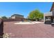 Large backyard with a pool, patio, decorative rock, trees, and privacy fence at 2036 S Reseda Ct, Gilbert, AZ 85295