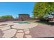 Landscaped backyard with a pool, decorative rock and concrete border at 2036 S Reseda Ct, Gilbert, AZ 85295