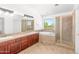 Bright bathroom features double sinks, a soaking tub, a stand-up shower, and a large window at 2036 S Reseda Ct, Gilbert, AZ 85295