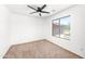 Bedroom featuring a ceiling fan and window with a view of the neighborhood at 2036 S Reseda Ct, Gilbert, AZ 85295