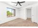 Well lit bedroom with a ceiling fan, closet and a view of the neighborhood at 2036 S Reseda Ct, Gilbert, AZ 85295