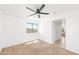 Bedroom featuring a ceiling fan, neutral carpet, a window, and sliding doors to an adjacent bathroom at 2036 S Reseda Ct, Gilbert, AZ 85295