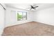 Well lit bedroom featuring a ceiling fan and window with view of the neighborhood at 2036 S Reseda Ct, Gilbert, AZ 85295