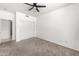 Bedroom features neutral walls, soft carpeting, a ceiling fan, and a closet at 2036 S Reseda Ct, Gilbert, AZ 85295