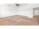 A spacious bedroom with a ceiling fan and a door leading to the hallway at 2036 S Reseda Ct, Gilbert, AZ 85295
