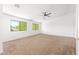 Spacious bedroom with neutral carpet, ceiling fan, and bright, natural light from two windows at 2036 S Reseda Ct, Gilbert, AZ 85295
