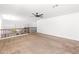 Spacious carpeted bonus room featuring neutral colored walls, a ceiling fan, and scenic backyard views at 2036 S Reseda Ct, Gilbert, AZ 85295