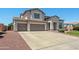 Expansive exterior elevation featuring a three-car garage, and well-manicured landscaping at 2036 S Reseda Ct, Gilbert, AZ 85295