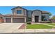 Beautiful two-story home showcasing a three-car garage, and well-maintained landscaping at 2036 S Reseda Ct, Gilbert, AZ 85295