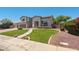 Charming home with a well-maintained lawn, mature trees, and a welcoming entrance at 2036 S Reseda Ct, Gilbert, AZ 85295