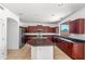 Kitchen with granite countertops, stainless steel appliances, and dark wood cabinetry at 2036 S Reseda Ct, Gilbert, AZ 85295