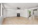 Spacious living room with fireplace, neutral tile floors, and ample natural light at 2036 S Reseda Ct, Gilbert, AZ 85295