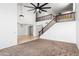Spacious living area featuring a grand staircase, tile flooring, and carpet at 2036 S Reseda Ct, Gilbert, AZ 85295