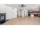 Bright living room with fireplace, tile floors, and open kitchen with island and dark wood cabinets at 2036 S Reseda Ct, Gilbert, AZ 85295