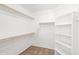 Functional walk-in closet with built-in shelves and rods for organized storage at 2036 S Reseda Ct, Gilbert, AZ 85295
