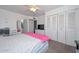 Bedroom with carpet, a ceiling fan, a white dresser with TV, and large closet at 2051 W Elm St, Phoenix, AZ 85015
