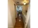 Hallway with wood floors leading to a kitchen with bright, natural light at 2051 W Elm St, Phoenix, AZ 85015