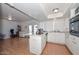 Open kitchen with white cabinets, an island cooktop, and plenty of counter space at 2051 W Elm St, Phoenix, AZ 85015