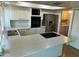 Spacious kitchen with stainless steel appliances and breakfast bar at 2051 W Elm St, Phoenix, AZ 85015