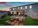 Backyard with artificial grass, patio seating, and a fire pit, perfect for outdoor entertaining at 20812 W Legend Trl, Buckeye, AZ 85396