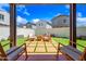 Beautiful backyard with a fire pit, patio, and green turf creating a great space at 20812 W Legend Trl, Buckeye, AZ 85396