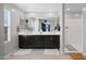 Modern bathroom with double sinks, sleek cabinets, and a glass-enclosed shower for a spa-like experience at 20812 W Legend Trl, Buckeye, AZ 85396