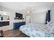 Comfortable bedroom with a decorative blue dresser and a view of the bathroom at 20812 W Legend Trl, Buckeye, AZ 85396