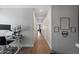Long hallway featuring hard wood floors with a visible office on one side at 20812 W Legend Trl, Buckeye, AZ 85396