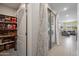 Hallway with pantry and doorway to the living space, with sliding glass doors at 20812 W Legend Trl, Buckeye, AZ 85396