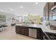 Bright and open kitchen area with stainless steel appliances, a large island, and bar seating at 20812 W Legend Trl, Buckeye, AZ 85396