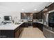 Well-appointed kitchen featuring dark cabinets, stainless steel appliances, and a large center island at 20812 W Legend Trl, Buckeye, AZ 85396