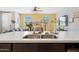 Open concept kitchen with stainless steel sink and fixtures, and view of the living room at 20812 W Legend Trl, Buckeye, AZ 85396