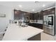 Spacious kitchen featuring dark cabinets, a large island, and stainless-steel appliances at 20812 W Legend Trl, Buckeye, AZ 85396